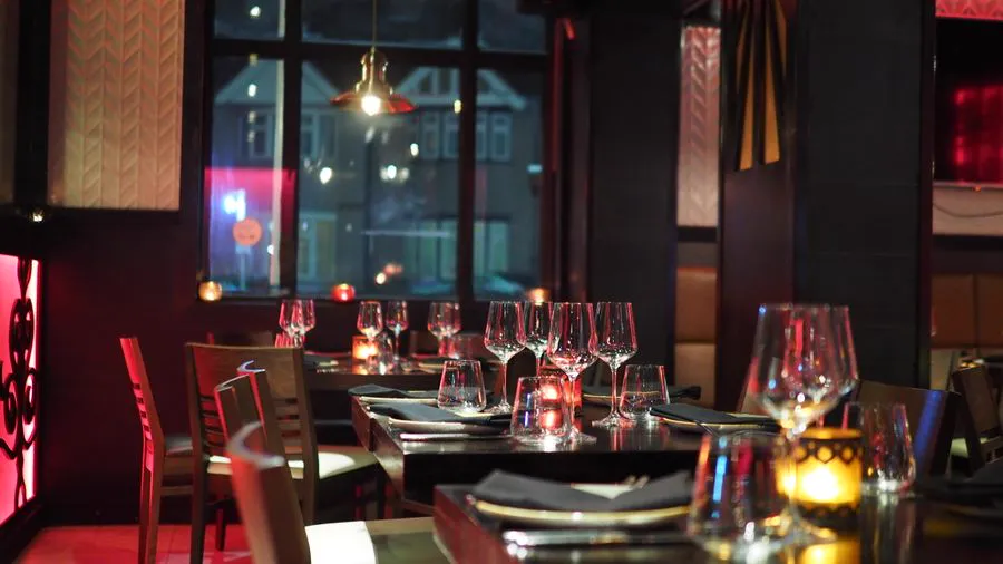 Candlelit restaurant table with elegant place setting and warm ambience